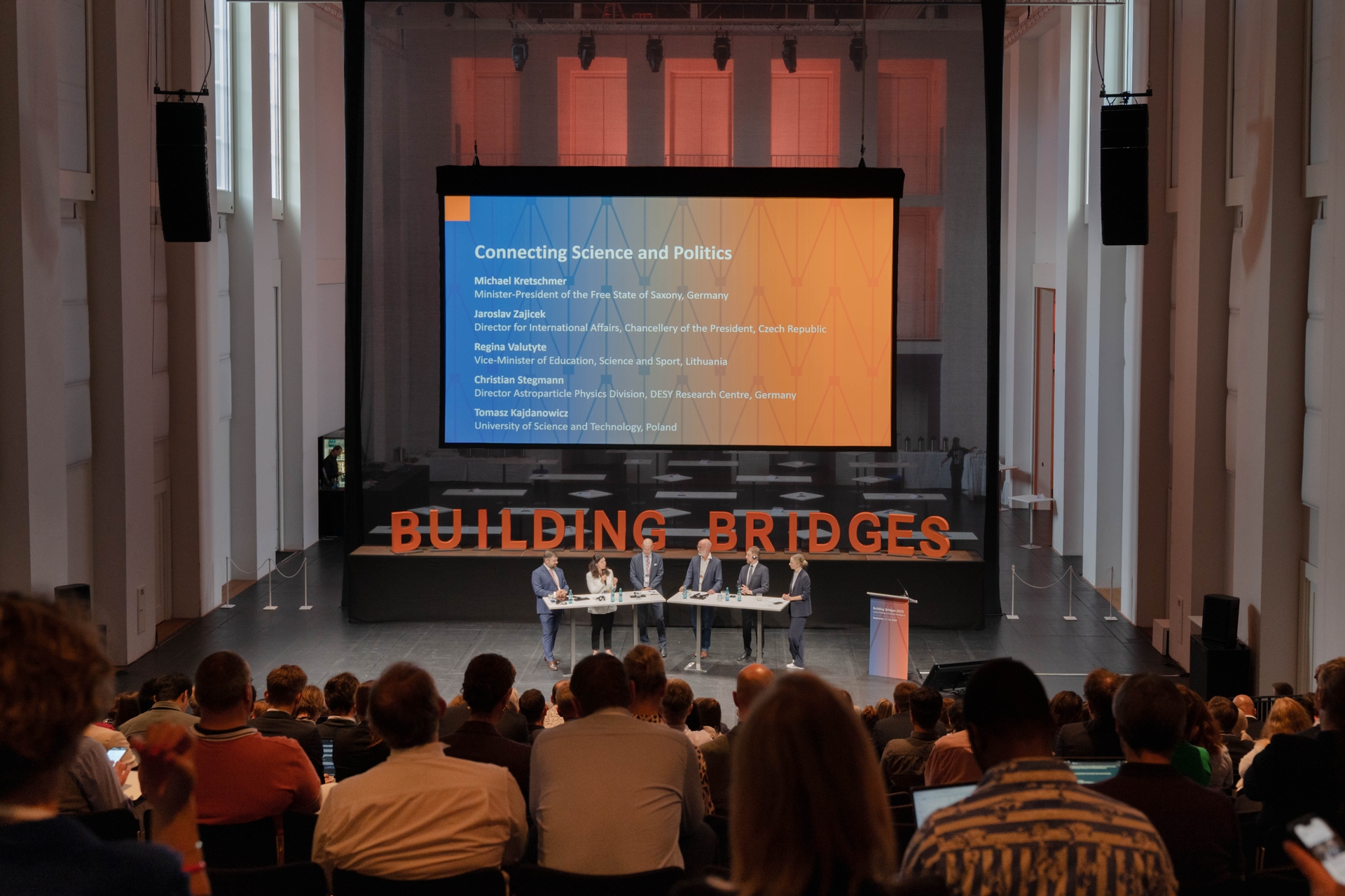 BuiBr9 Das Foto zeigt ein Panel von sechs Personen. Im Hintergrund steht auf einer Präsentation "Connecting Science and Politics".